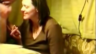 Brunette milf giving some guy head without any idea she is being filmed.