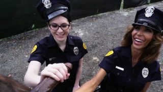 Two female police strip a black man