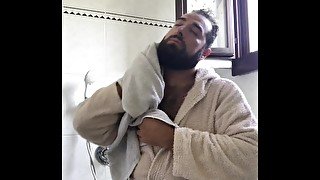 Big Italian bearded bear dry his hairy body after taking a shower after workout