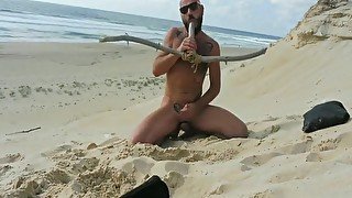 Bearded stud fucks himself on beach