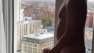 Exhib jerk off and cum over cityscape view.