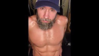 Bearded jock strokes his long cock