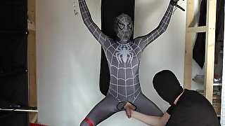 Ballbusting and electro on the balls of tied black Spiderman