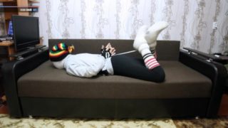 Encasement bondage in sweatpants striped socks and slipper boots