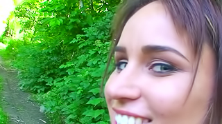 Pretty teen with blue eyes is naked and sucking dick in the forest