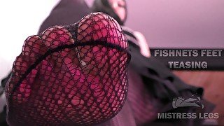 Mistress feet closeup teasing in black fishnets on the ladder