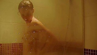 Solo brunette rubbing and gaping her pussy while showering