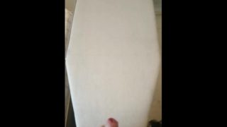 Huge cumshots spray over an ironing board and onto the wall