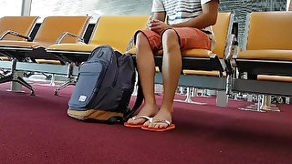 Boy put on flip flops and anklet in airport