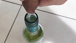 Filling up a 750mL bottle of wine with piss