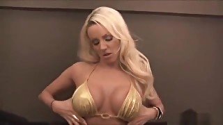 Gorgeous busty blonde talking dirty in gold bikini