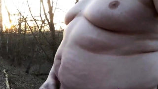 Chubby masturbates in the woods