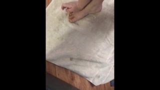 Cute tiny girl feet getting yellow nail polish