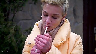 Short Cut Hair Blonde Girl Is Smoking All White 120mm Cigarettes