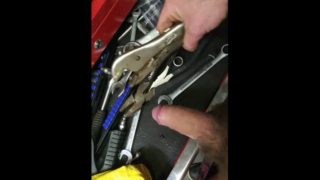 Mechanic plays with his tools