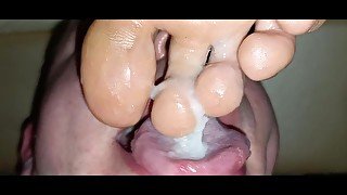 Eating huge load of cum from between her dirty toes