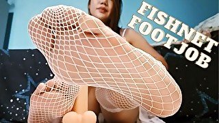 Practicing Footjob in Fishnets on a Dildo