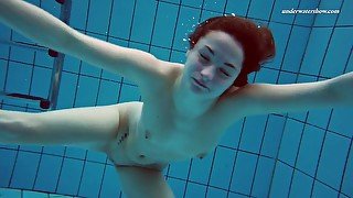 Redhead babe Liza Bubarek with natural tits stripping in the pool