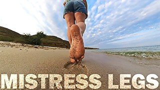 Barefoot Girl Walks Over The Summer Seashore