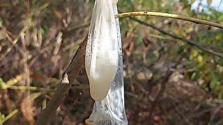 Young horny twink found a used condom in the woods, so he put his cock in it and spermed