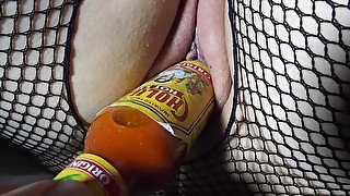 Some wild insertion of bottle into shaved wet pussy closeup