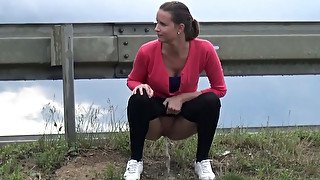 Charming brunette teen in leggings caught pissing near the rod