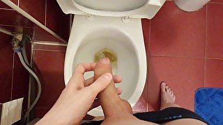 Teen pees in the toilet and gently touches the penis