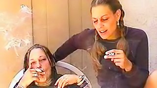 Two sexy chicks smoke together