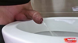 Uncircumcised cock peeing with a big stream