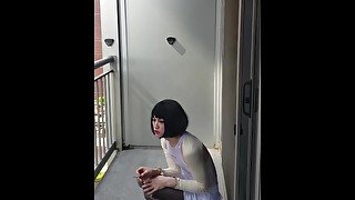 Crossdresser takes a smoke break while cuffed