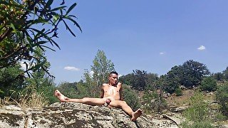 Gay male spread his legs and ass to take an anal vibrator in a public park