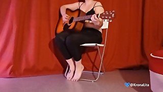 the girl plays the guitar and undresses