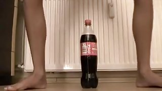 Small immature tries to ride a coke bottle