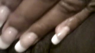 Horny black hooker is fondling her cunt with fingers