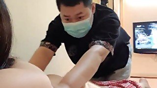 Asian masseur rubs clients clit and inserts her a sex toy