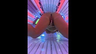 Thick milf gets horny at the tanning salon, masturbates and squirts all over the sunbed