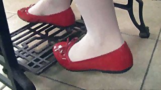 Pretty brunette chick Petra wears red flats while working with sewing machine