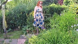 Busty babe Red XXX fingers herself in the garden