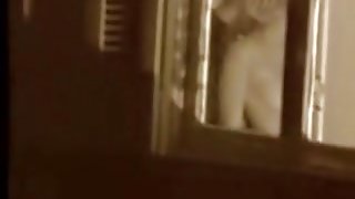 Man kissing the naked lover on window voyeur movie