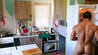 muscle man coocking and eating naked