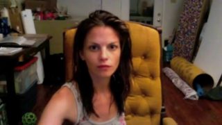 Brunette masturbating on a chair