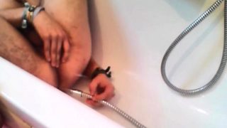 Bi-guy using shower head, squirting water, enema