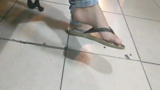 College girl feet dangling in flip flops delicious soles