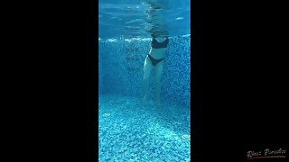 A Russian is swimming in the pool. view of pd with water on a naked girl