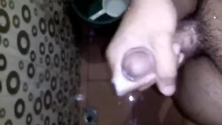 Horny Young Guy Having Fun Jerking Off His Huge Cock in the Toilet