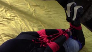 Laura XXX is wearing panthyhose and high heels. She's hogtied, masked, blindfolded and ballgagged