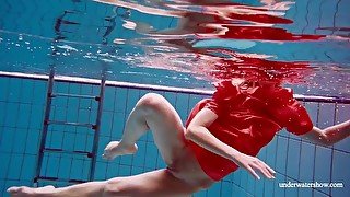 Cute babe in red sexy open dress swimming