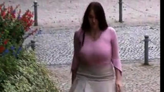 Busty girl walking, no bra, jiggling