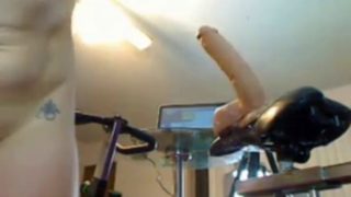 Blonde riding a huge dildo on a bicycle on webcam