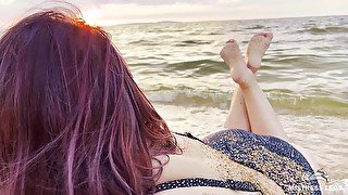 Beautiful wrinkled soles and toes wiggling against the backdrop of a sunset on the sea beach